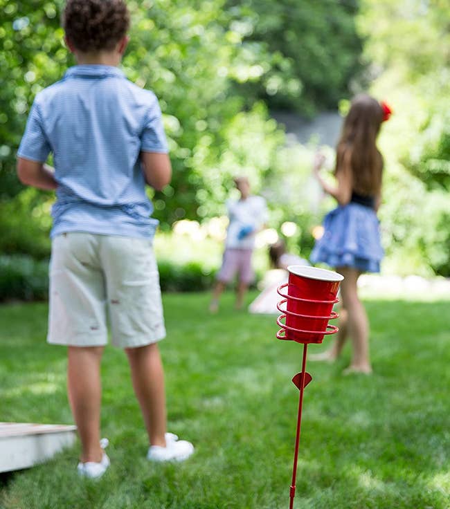 a red stake in the ground holding a red solo cup