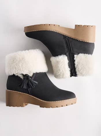 Stylish achromatic  wintertime  ankle boots with faux fur trim, tassels, and a chunky sole shown from broadside  and apical  view