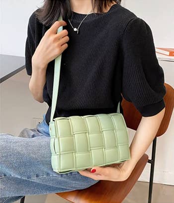 the same model wearing the bag in green
