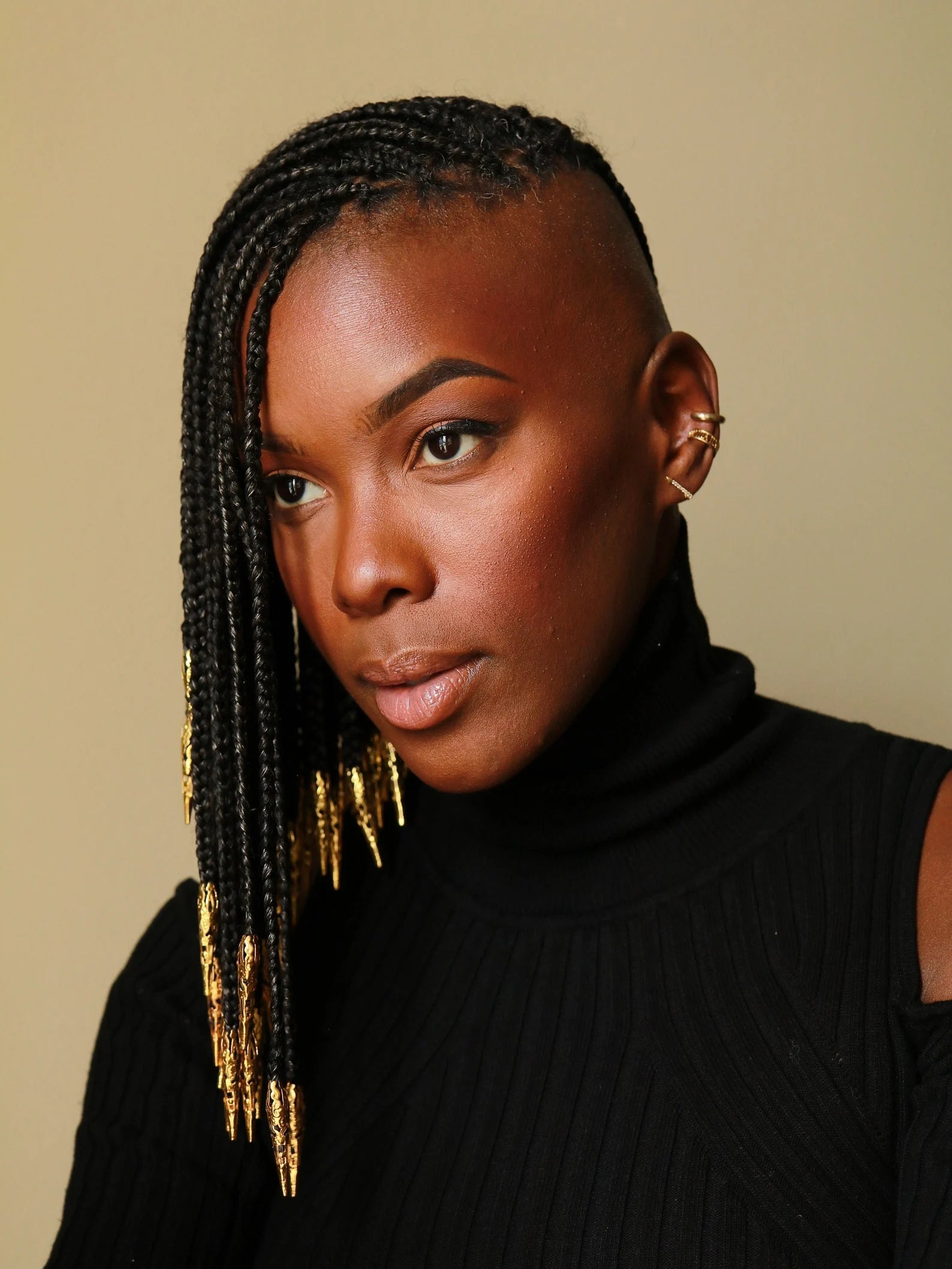 model wearing gold loc beads in their hair
