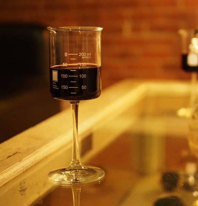 the beaker wine glass full of red wine