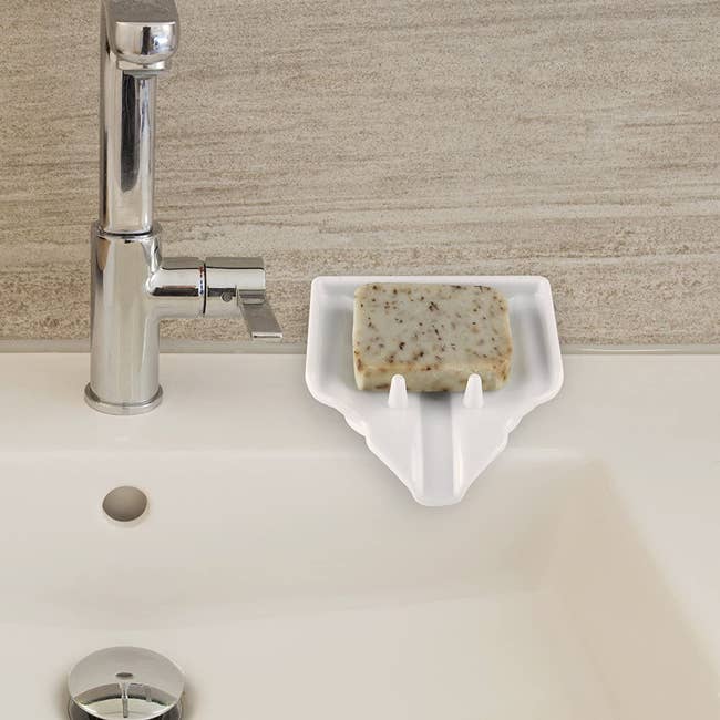 The soap dish on the side of a sink. It's angled downward with little poles to keep the soap in place, but also a channel to funnel residue downward
