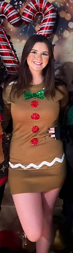 reviewer posing in gingerbread dress