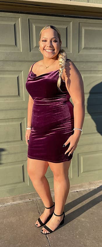 reviewer wearing the purple velvet dress in an XXL