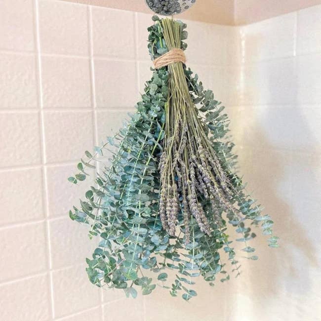 Bunch of eucalyptus and lavender hanging upside down for drying successful a tiled area