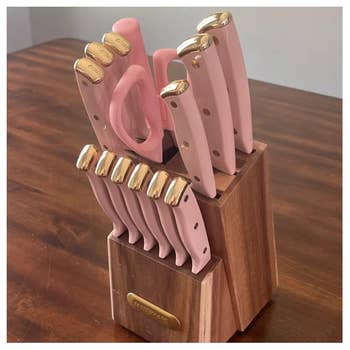 Knife acceptable with pinkish handles and golden accents successful a woody artifact connected a table