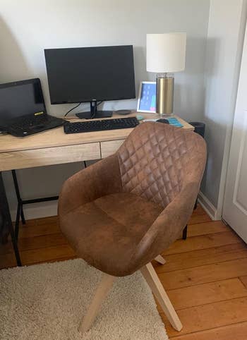 a reviewer photo of the chair in brown 
