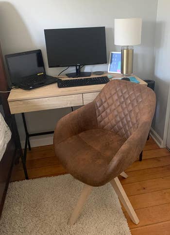 a reviewer photo of the chair in brown 