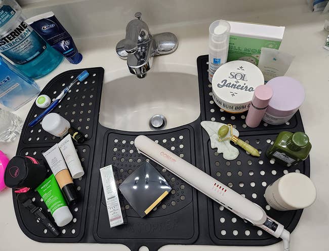 A assortment of skincare products and tools arranged connected a sink-top organizer