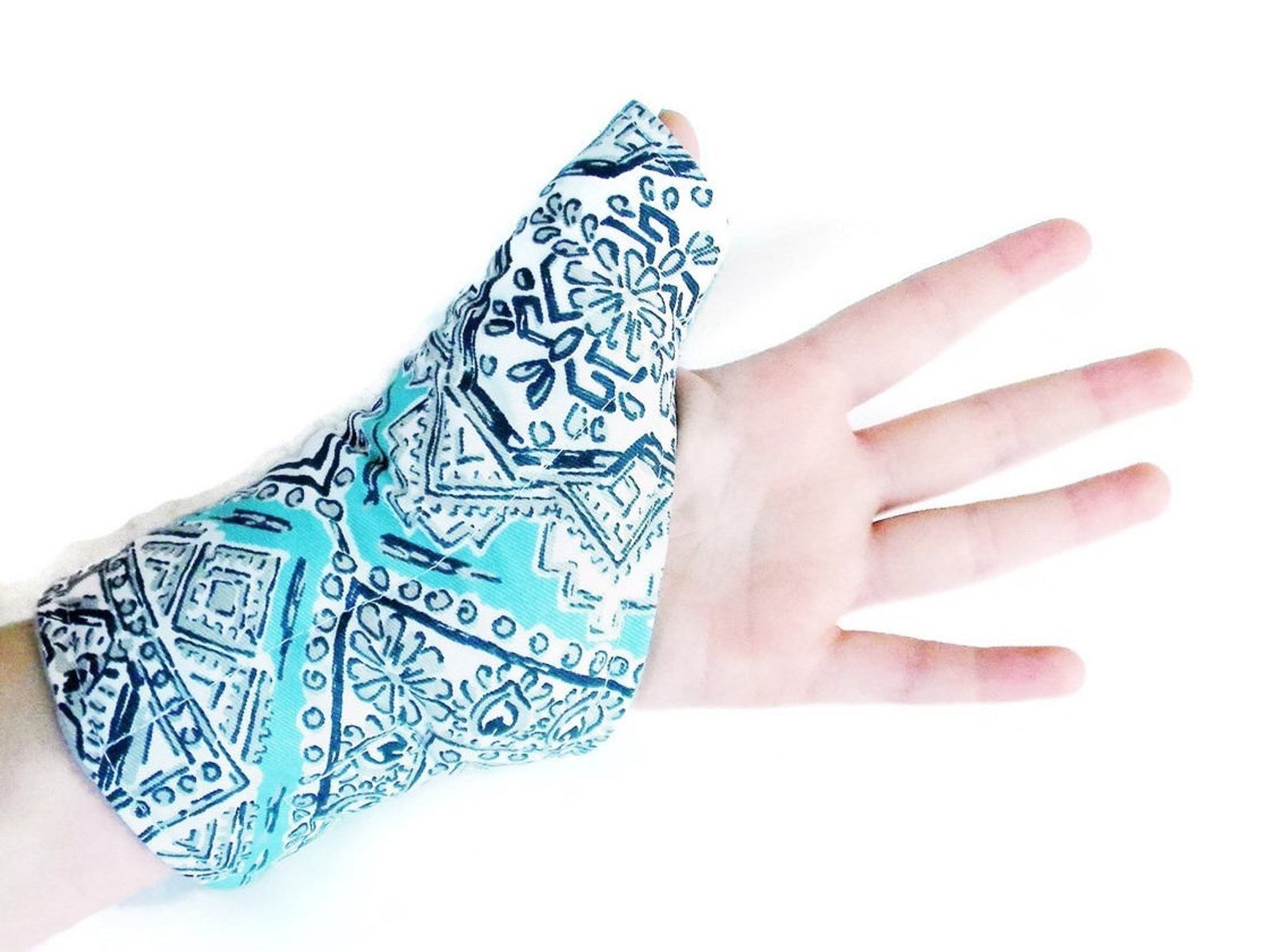 Model wearing blue pack that covers the bottom of their hand, wrist, and thumb