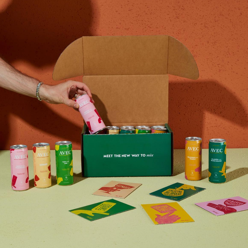 model grabbing one of the cans out of the sampler box
