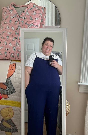reviewer wearing the jumpsuit with a white tee underneath