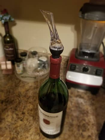 reviewer photo of the pourer and aerator attached to wine bottle