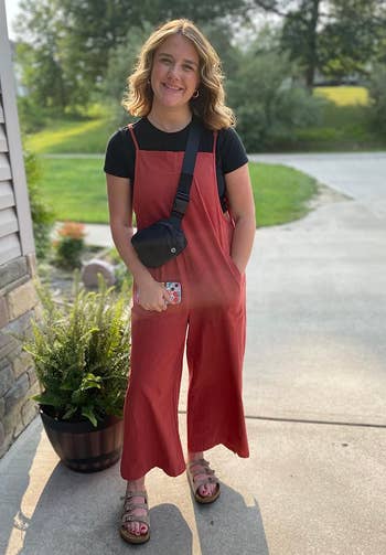 another reviewer wearing rust colored overalls