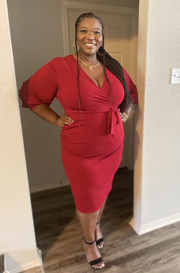 Reviewer wearing red midi dress