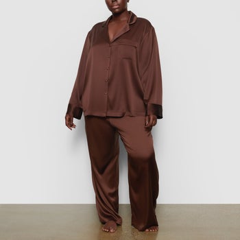 model wearing coffee-colored silk pajamas