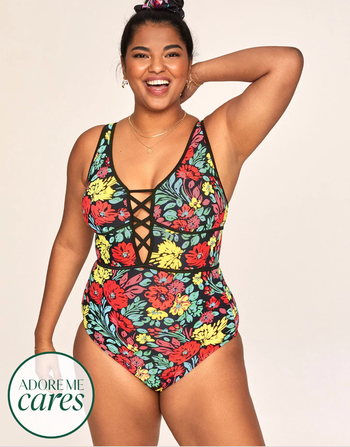 Model in a bright floral yellow red and green one piece with a faux plunge neckline 