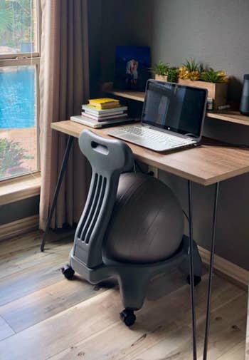 the gray exercise ball chair at a home office desk