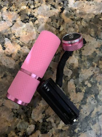 reviewer photo of pink nail flashlight, disassembled