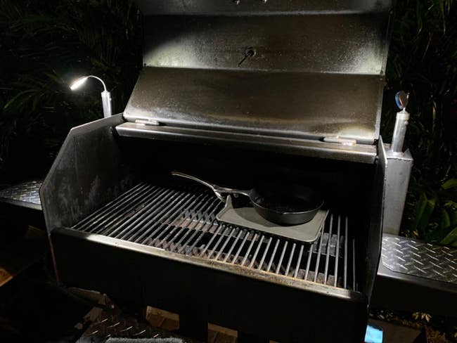 a reviewer photo of a grill with a magnetic light mounted on each side 