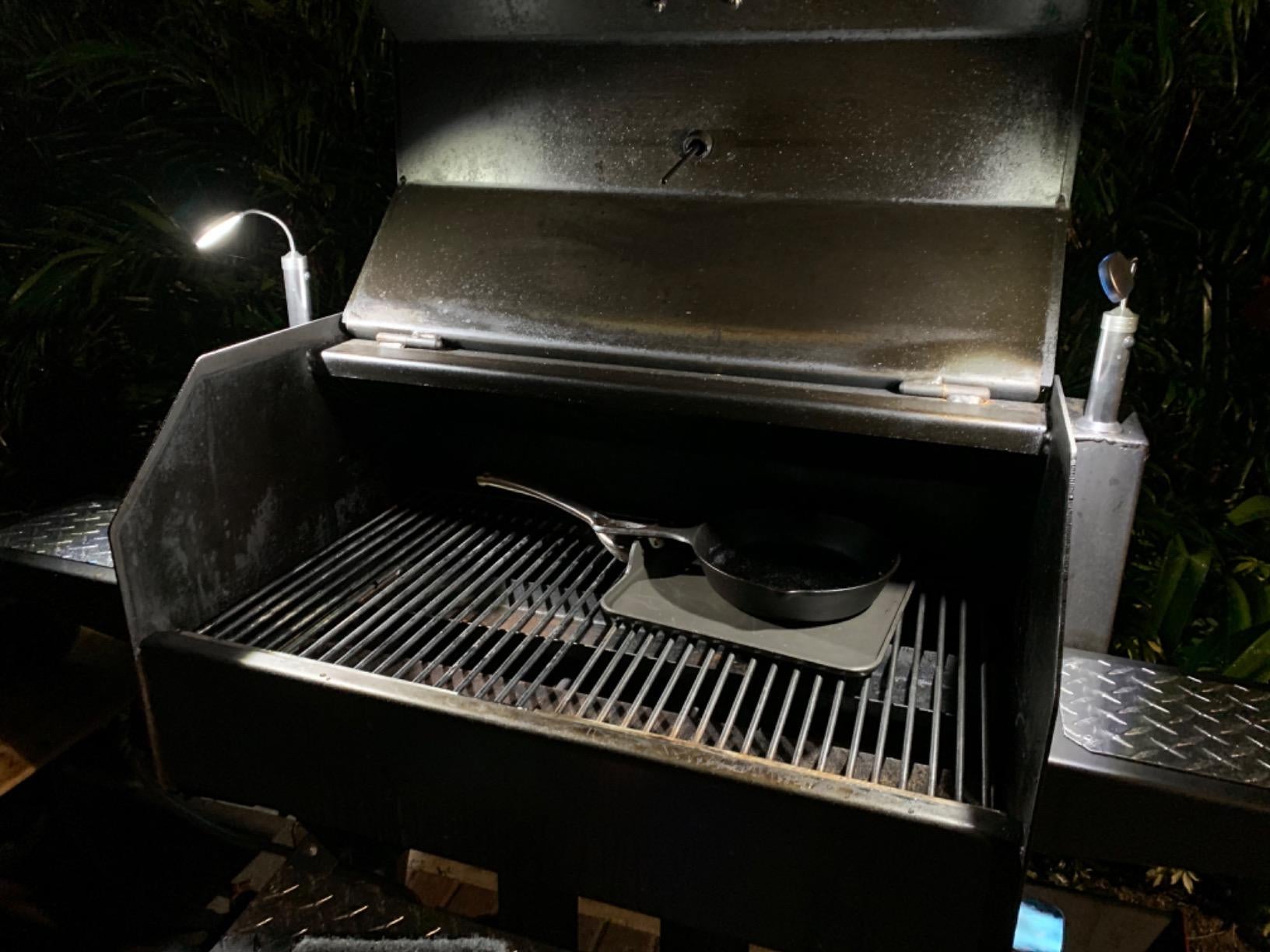 a reviewer photo of a grill with a magnetic light mounted on each side