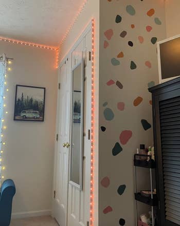 another reviewer showing their bedroom with one of the walls embellished with the decals 
