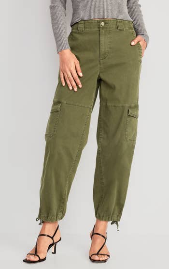 a model wearing the pants in khaki green 