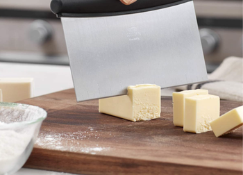 Model using the scraper to cut butter 