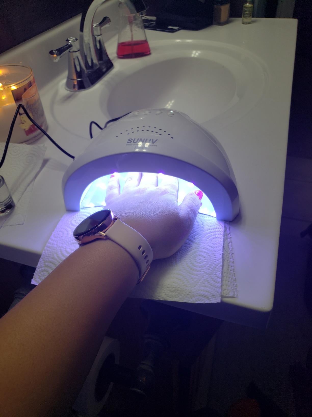 image of reviewer's hand under the UV LED lamp