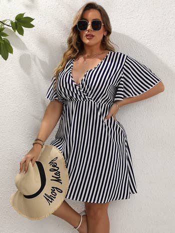 model wearing the dress in blue and white stripes