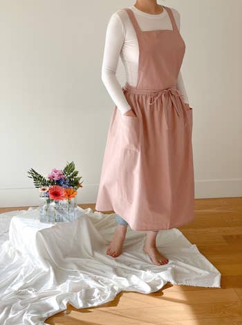 model showing the front side of the pink dress apron