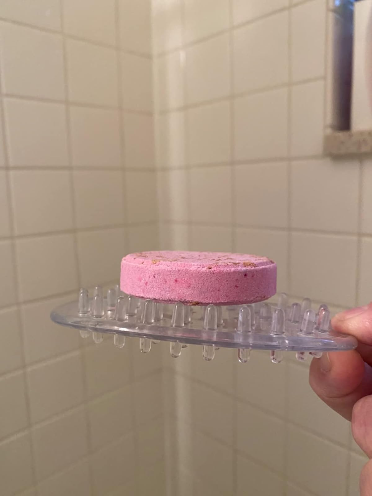 Pink shampoo barroom  connected  a wide   silicone brushwood  holder with grip bristles, successful  a tiled ablution  setting