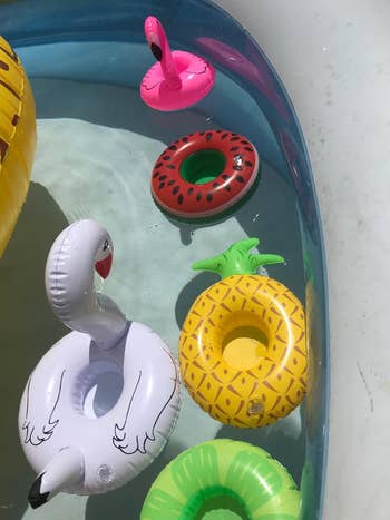 Reviewer pic of the different floaties like a pineapple one, a swan, and a flamingo