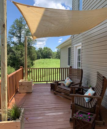 a reviewer photo of a back deck with a sand-colored canopy hung overhead 