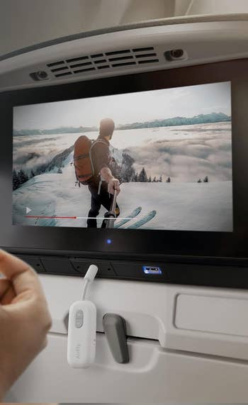 AirFly device plugged into airplane seat’s tv