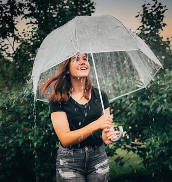 reviewer standing under a clear umbrella 