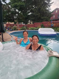 another reviewer photo of two people in the inflatable hot tub