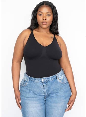 reviewer wearing the black tank bodysuit with blue jeans