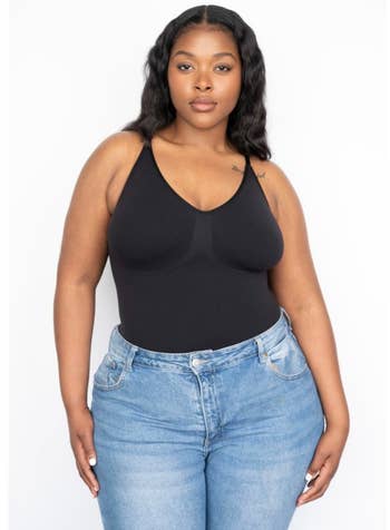 reviewer wearing the black tank bodysuit with blue jeans