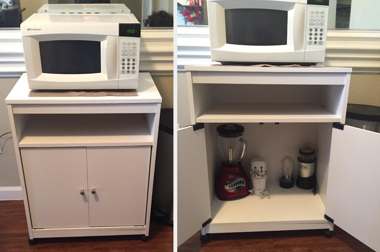 Reviewer image of white cabinet microwave cart with white microwave on top shelf on hardwood floor, cabinet doors open with cooking appliances inside
