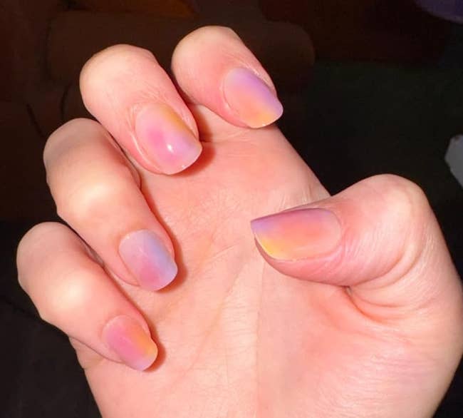 Close-up of a manus with short, clean, translucent nails, showing a neat and earthy manicure