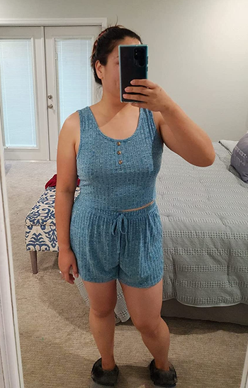 a reviewer wearing the matching tank top and shorts n light blue