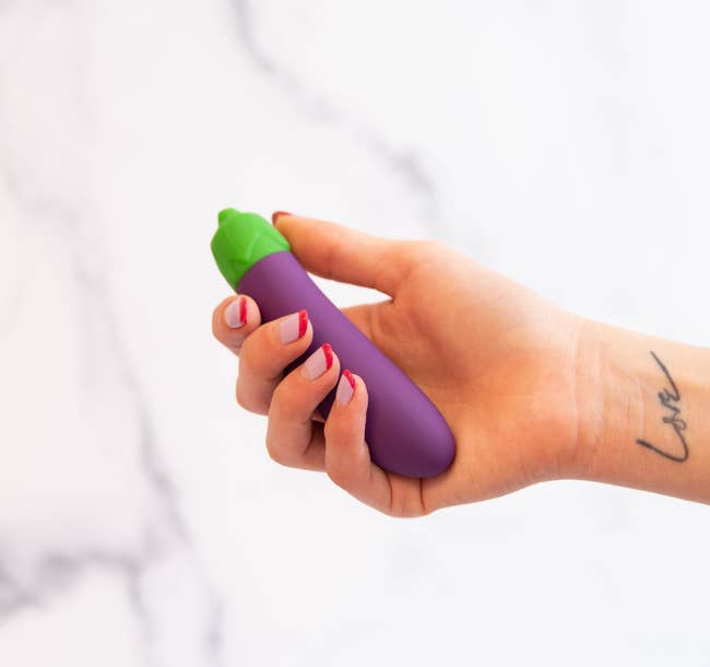 hand holding the eggplant vibrator