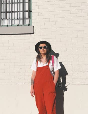 another reviewer wearing brick red overalls