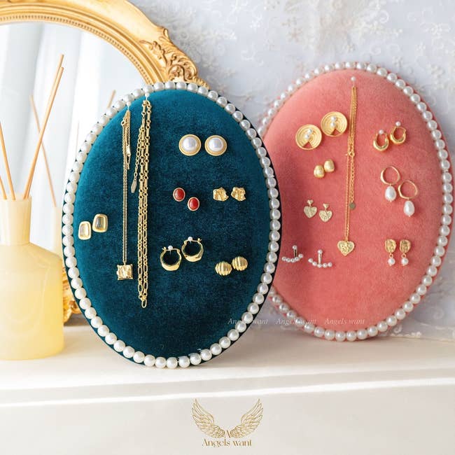 teal and pink velvet organizers holding various pieces of jewelry
