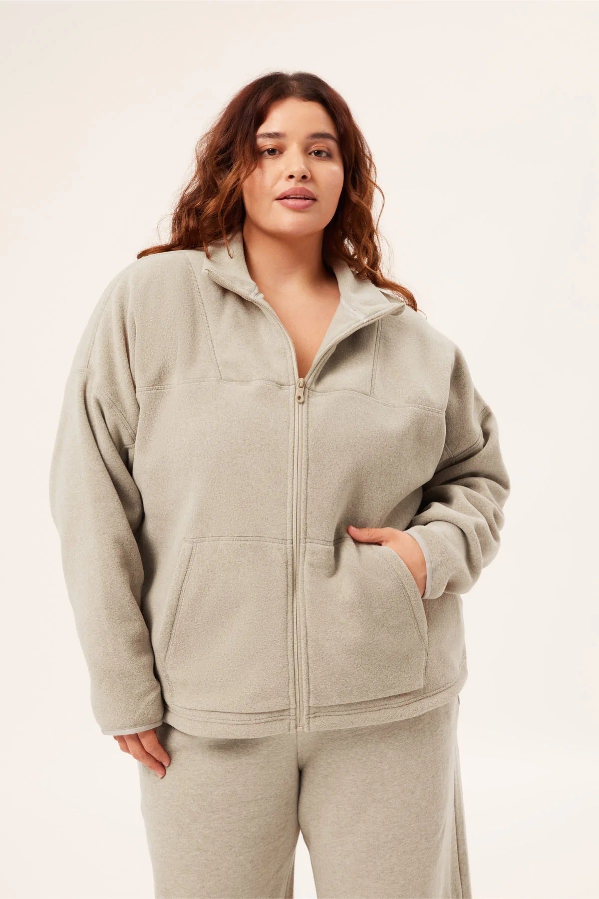 model wearing full zip fleece jacket in a light beige color