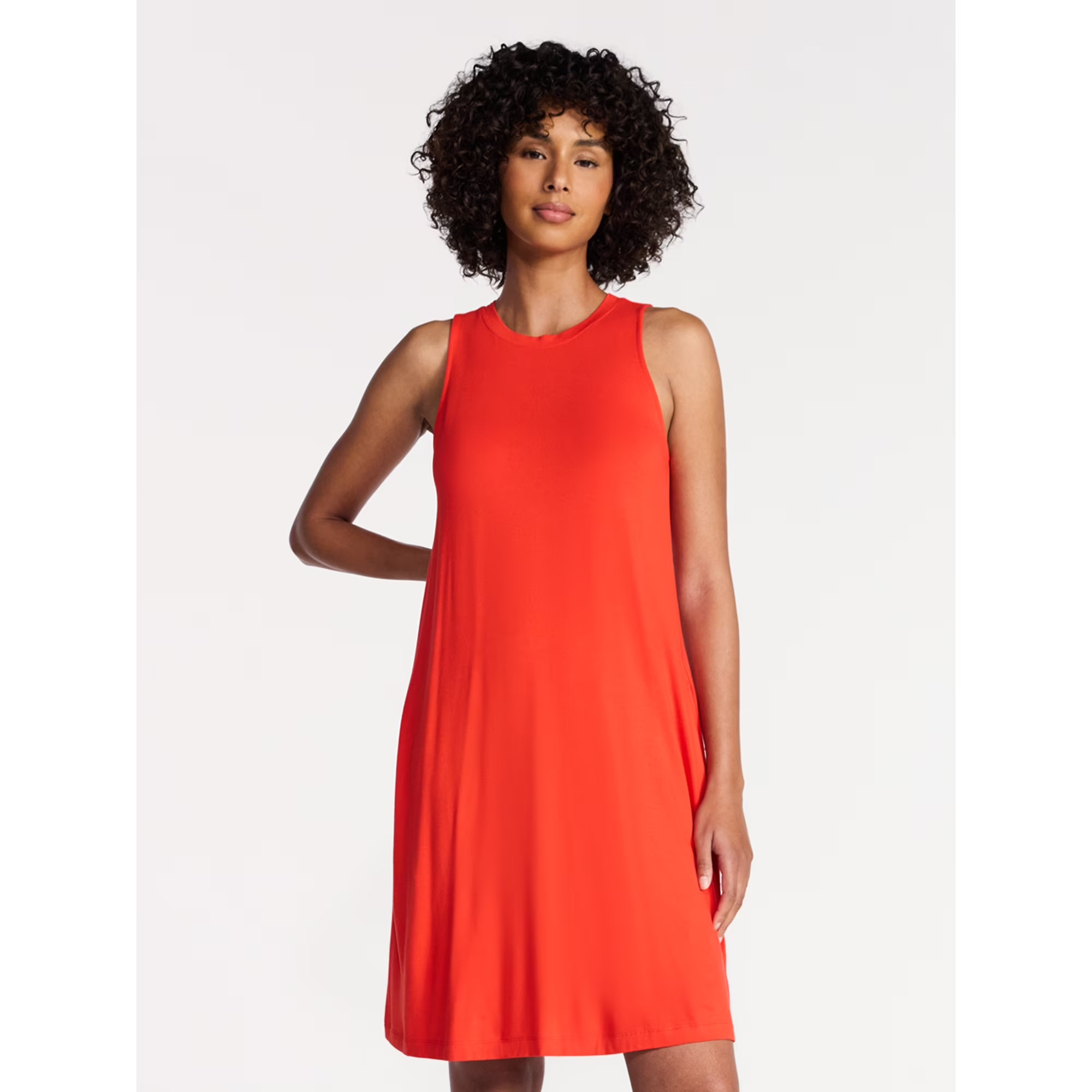Person wearing a sleeveless, knee-length dress, lasting  against a plain background, suitable for casual oregon  summertime  wear