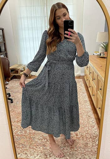 a reviewer wearing the long sleeve midi dress in blue with white dots 