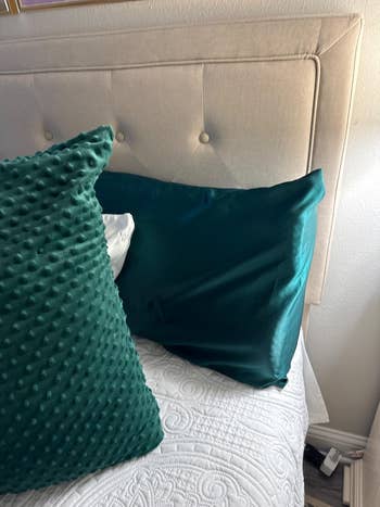 Bed with textured and creaseless pillows connected a quilted cover, showcasing a cozy and stylish chamber setting