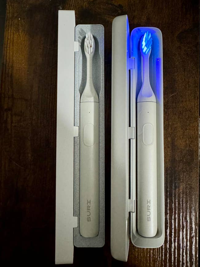 Two SURI electric toothbrushes in UV cleaning travel case